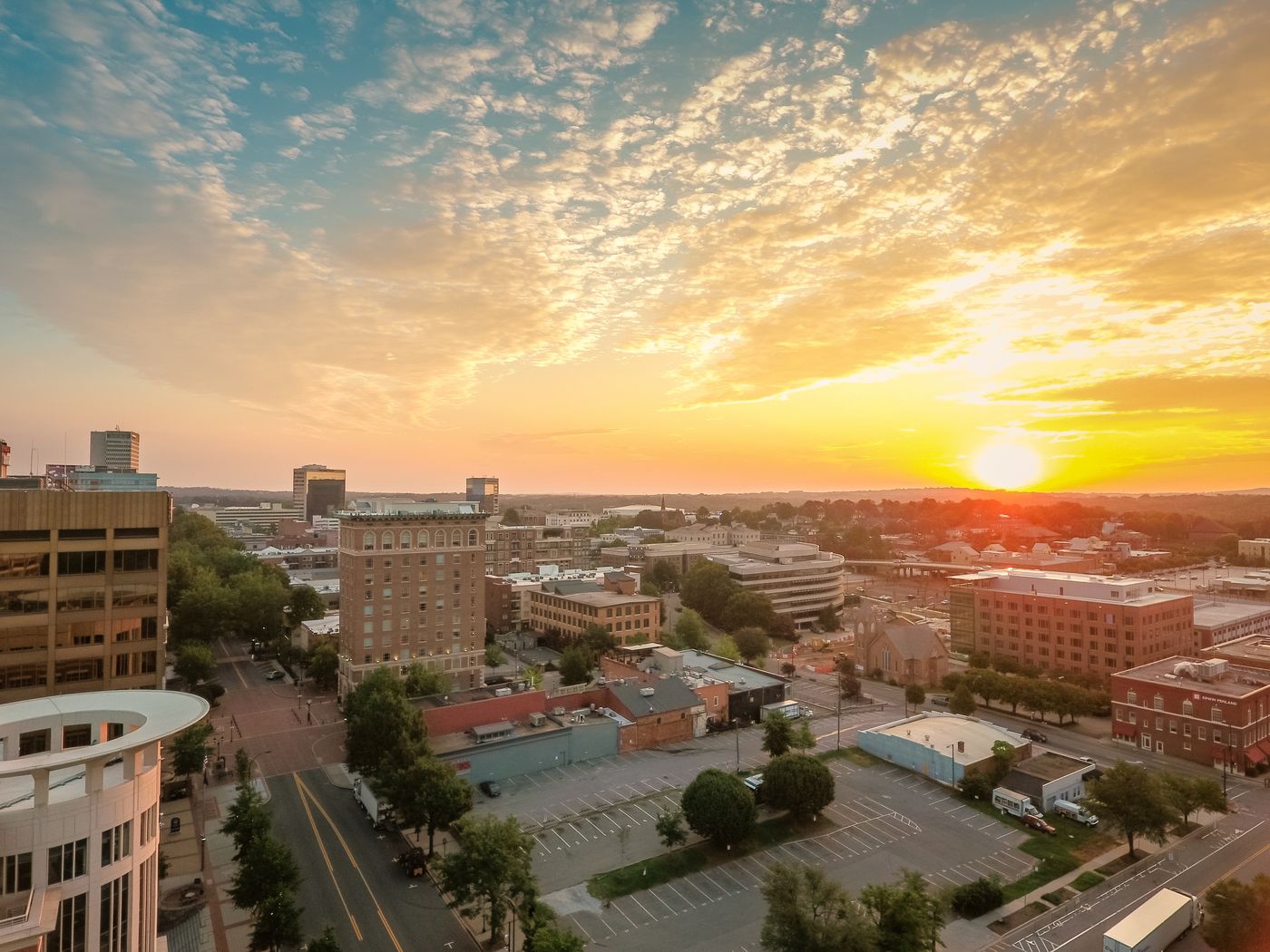 An aerial view of a small downtown at sunset